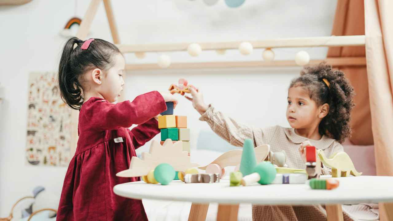 Smiling daycare provider playing with children in a safe and nurturing home environment